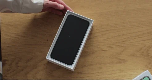 woman-opens-box-new-smartphone-260nw-2284139809